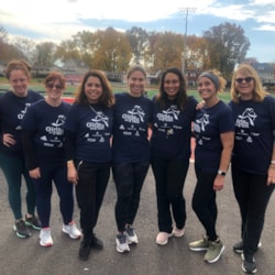 Volunteers gather in dark Girls on the Run t-shirts